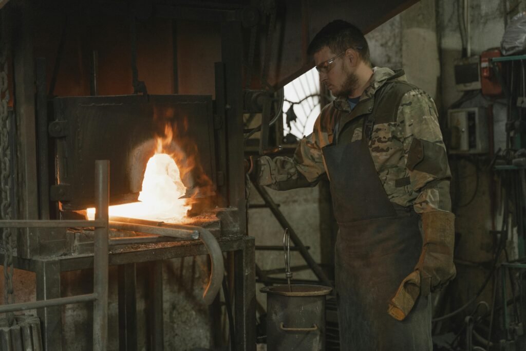 A skilled blacksmith operates a forge in a workshop, crafting metal with precision and care.